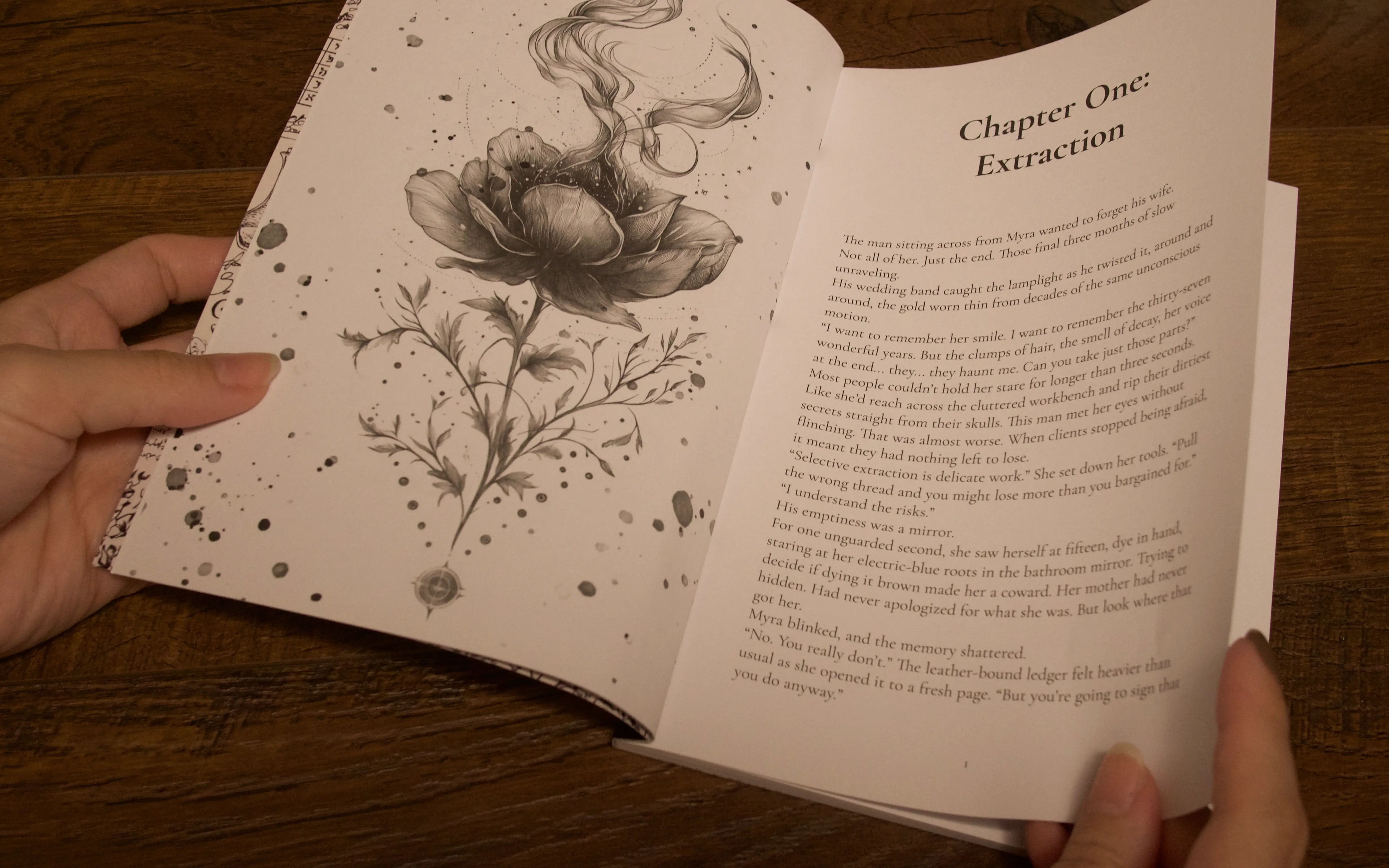 Hands holding open the first Everlore Hollow episode over a walnut table